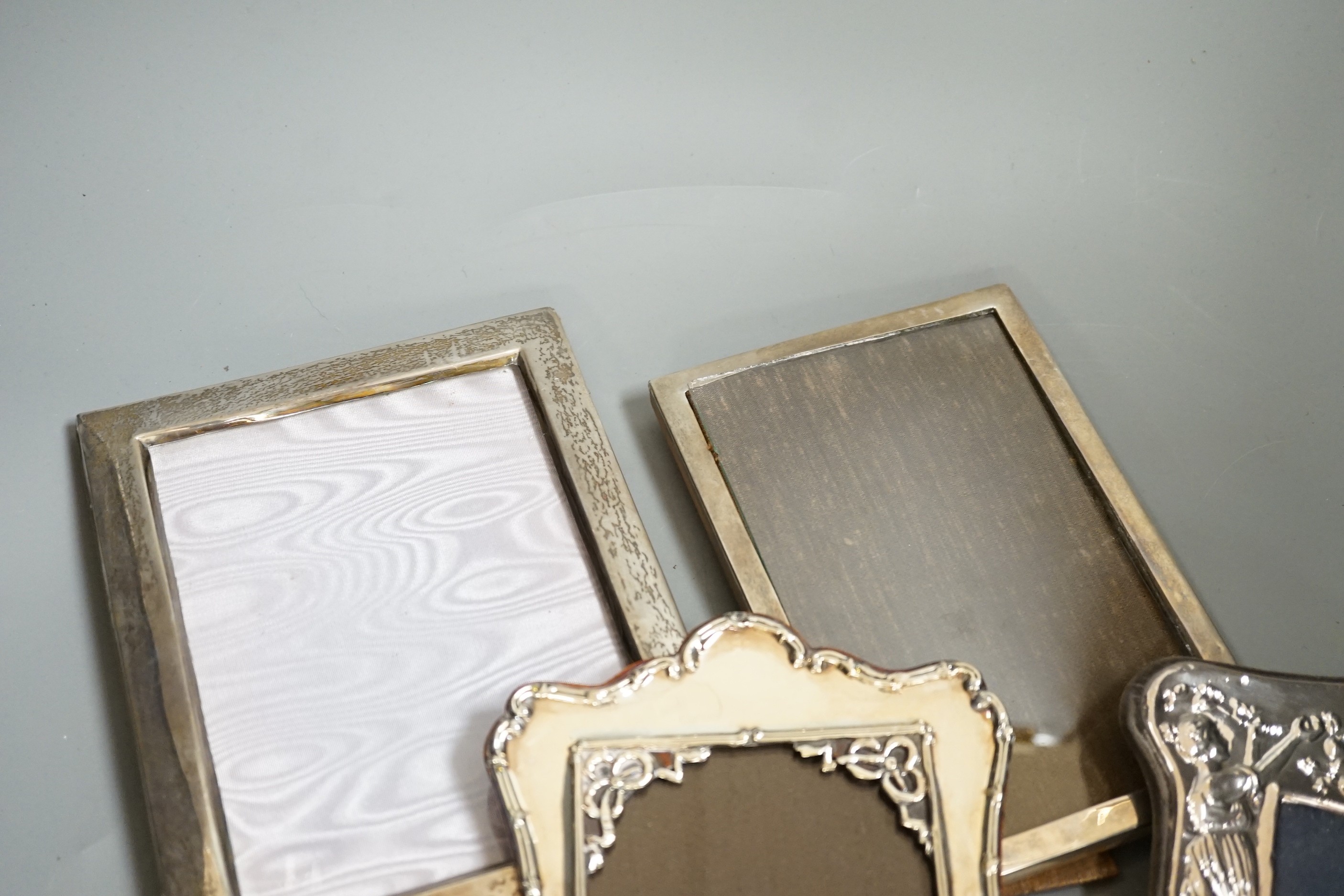 Four assorted silver mounted photograph frames including Edwardian, Chester, 1906, largest 19.9cm.